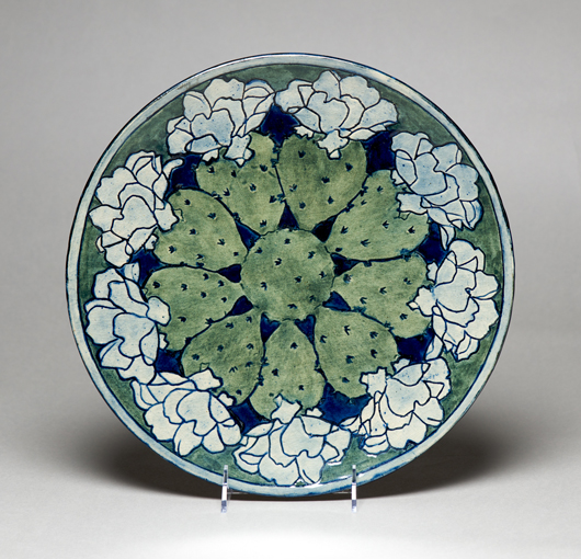 From the exhibition, this rare plate was decorated with an overall cactus design around 1903 by Newcomb College student Harriet Joor. As usual, resident potter Joseph Meyer created the clay form, which was incised, painted, and finished with a glossy glaze. Newcomb Art Collection, Tulane University